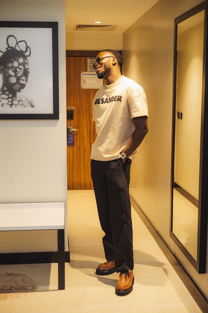 Portrait of a fashionable man standing indoors, reflecting modern style and elegance.